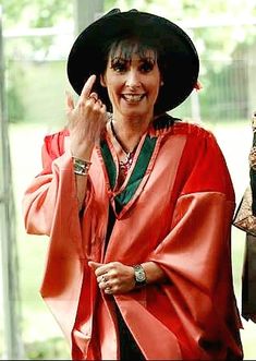 Enya Galway University picture pointing up at hat